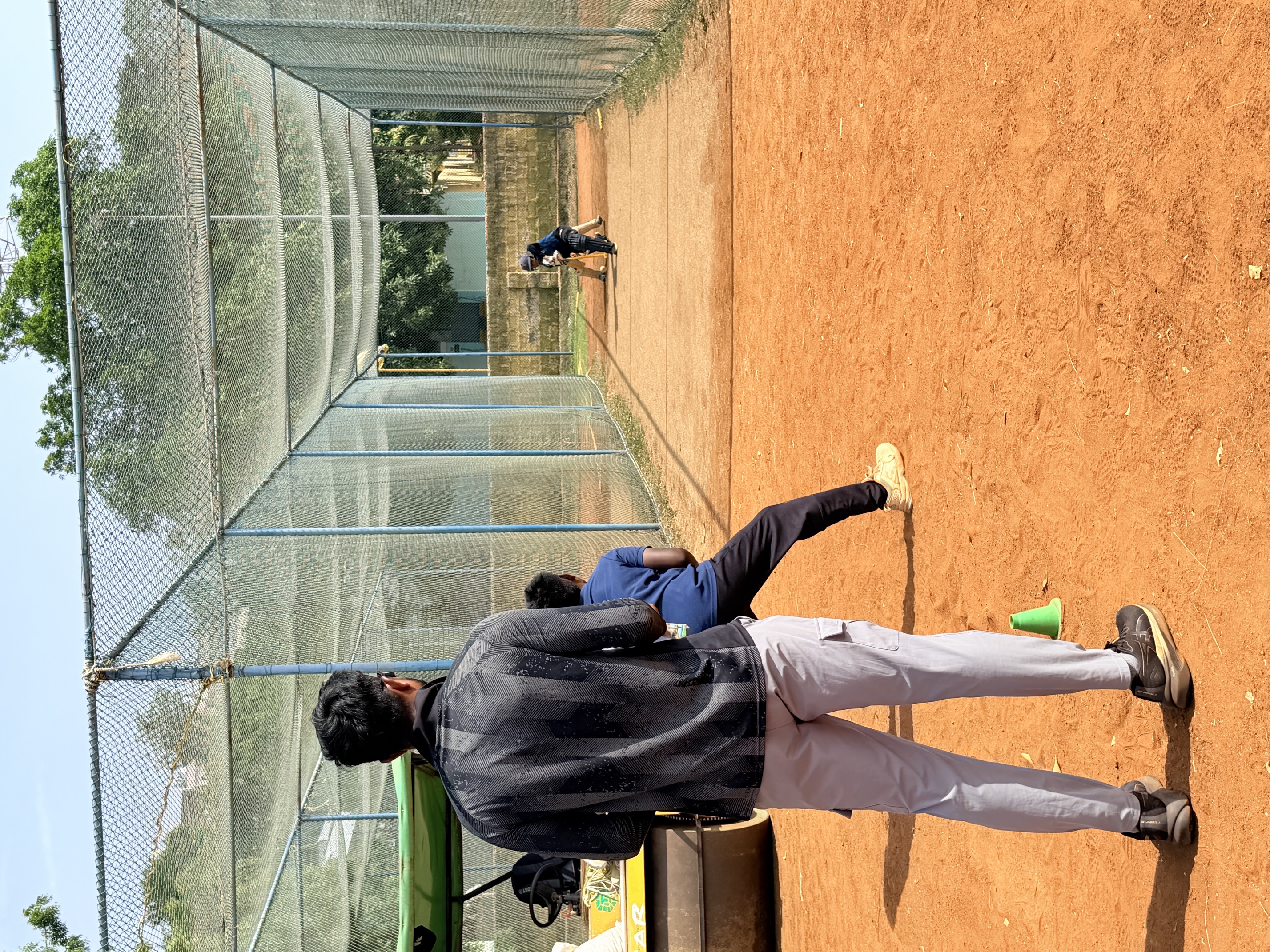 Coach watching a batting session from outside the nets