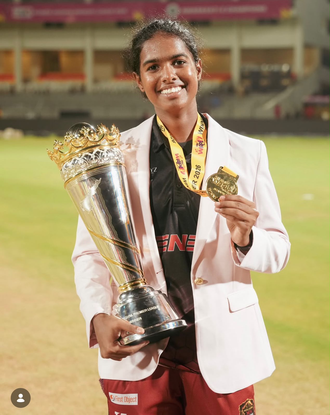 Setu Sai holding a cricket trophy and medal